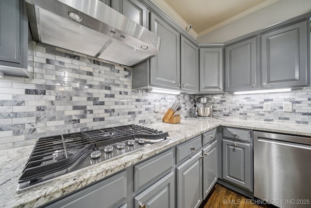 3701 W Dallas St, Broken Arrow, OK 74012 - kitchen with stainless steel appliances, gray cabinetry, extractor fan, crown molding, and decorative backsplash