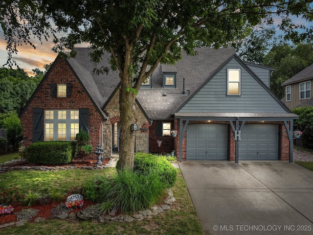 3701 W Dallas St, Broken Arrow, OK 74012 - view of front of house featuring driveway, a garage, brick siding, and roof with shingles