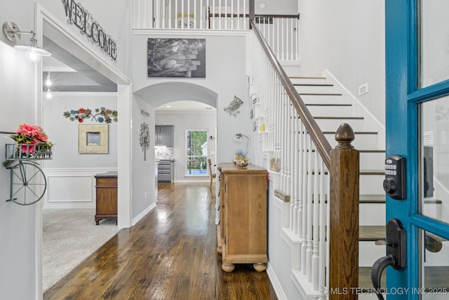 3701 W Dallas St, Broken Arrow, OK 74012 - entryway with a high ceiling, arched walkways, dark wood-style floors, stairway, and crown molding