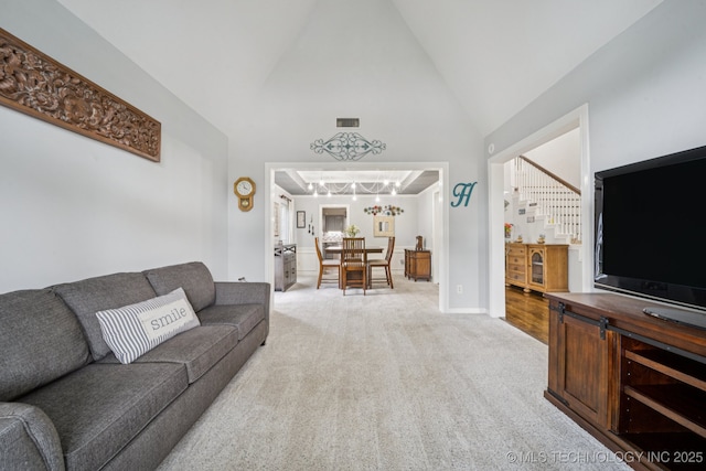 3701 W Dallas St, Broken Arrow, OK 74012 - living area with light carpet, high vaulted ceiling, and a chandelier