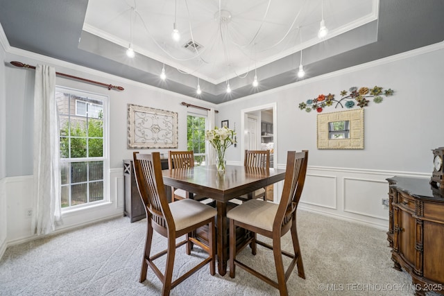 3701 W Dallas St, Broken Arrow, OK 74012 - dining space with crown molding, a tray ceiling, a decorative wall, light carpet, and plenty of natural light