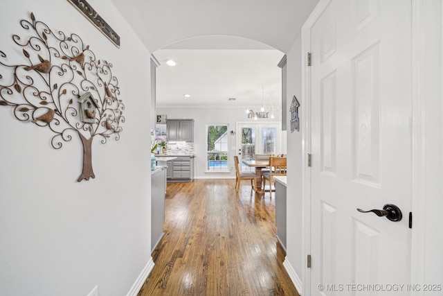 3701 W Dallas St, Broken Arrow, OK 74012 - hall with arched walkways, wood finished floors, and recessed lighting