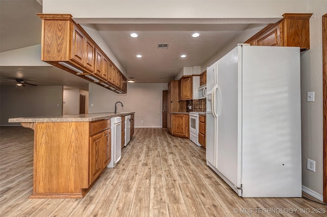 710 N Brethren Rd, Cushing, OK 74023 - kitchen featuring white appliances, light wood-type flooring, recessed lighting, brown cabinets, and a ceiling fan