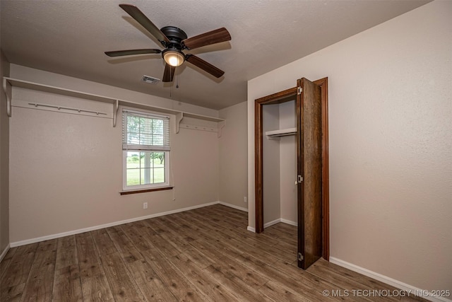710 N Brethren Rd, Cushing, OK 74023 - unfurnished bedroom featuring wood finished floors, a ceiling fan, and a closet