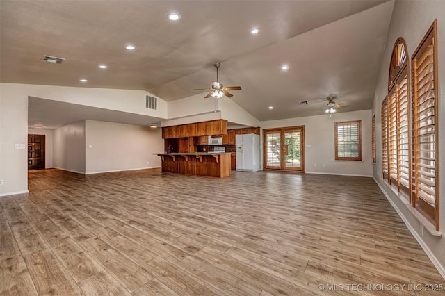 710 N Brethren Rd, Cushing, OK 74023 - unfurnished living room featuring a ceiling fan, vaulted ceiling, light wood-type flooring, and recessed lighting