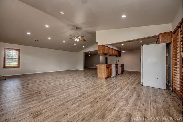 710 N Brethren Rd, Cushing, OK 74023 - unfurnished living room featuring ceiling fan, light wood finished floors, lofted ceiling, and recessed lighting