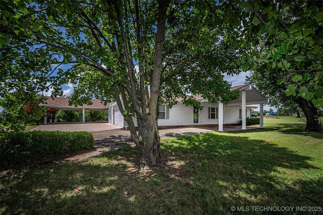 710 N Brethren Rd, Cushing, OK 74023 - view of green lawn with concrete driveway and a carport