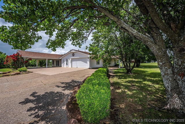 710 N Brethren Rd, Cushing, OK 74023 - single story home featuring an attached garage, a front lawn, driveway, and a carport
