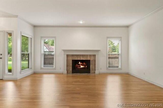 1620 S Florence Pl, Tulsa, OK 74104 - unfurnished living room featuring ornamental molding, wood finished floors, and a fireplace
