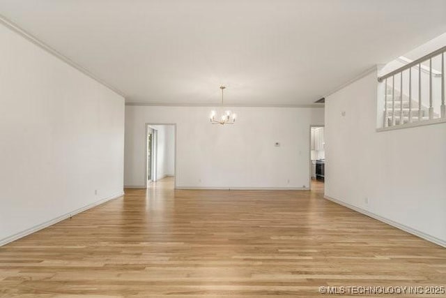 1620 S Florence Pl, Tulsa, OK 74104 - unfurnished living room featuring a chandelier, light wood-type flooring, and crown molding