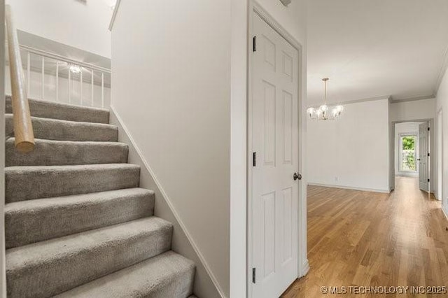 1620 S Florence Pl, Tulsa, OK 74104 - staircase featuring wood finished floors, a chandelier, and ornamental molding