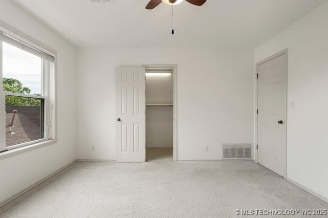 1620 S Florence Pl, Tulsa, OK 74104 - unfurnished bedroom featuring carpet floors, a walk in closet, ceiling fan, and a closet