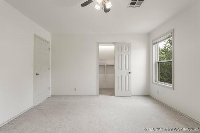 1620 S Florence Pl, Tulsa, OK 74104 - unfurnished bedroom featuring carpet flooring, a walk in closet, and ceiling fan