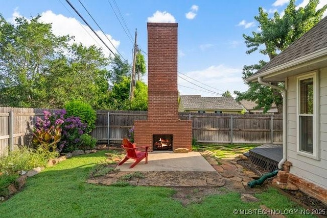 1620 S Florence Pl, Tulsa, OK 74104 - fenced backyard with an outdoor brick fireplace and a patio area
