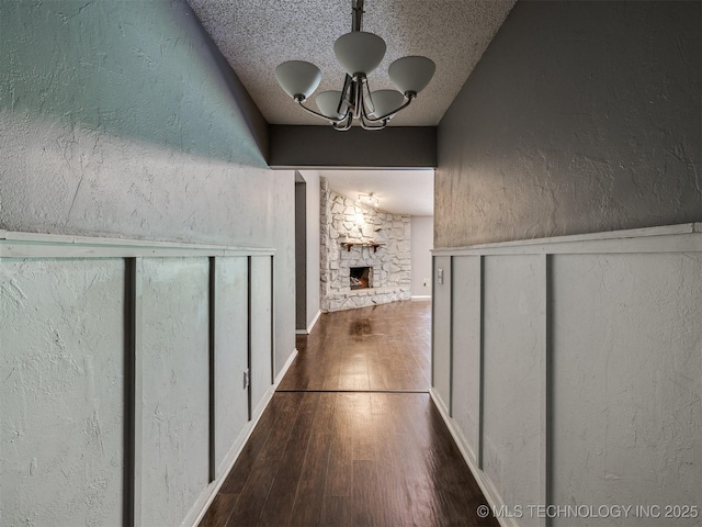 117 W Timberlane St, Broken Arrow, OK 74011 - hallway featuring wood finished floors, a chandelier, a textured wall, and a textured ceiling