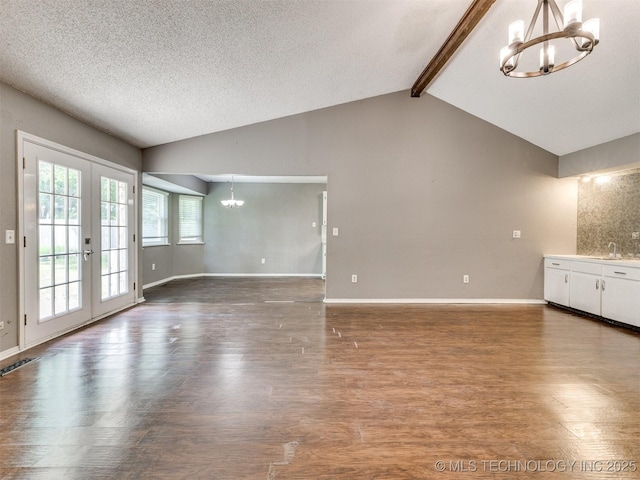117 W Timberlane St, Broken Arrow, OK 74011 - unfurnished living room featuring a chandelier, wood finished floors, french doors, and a textured ceiling