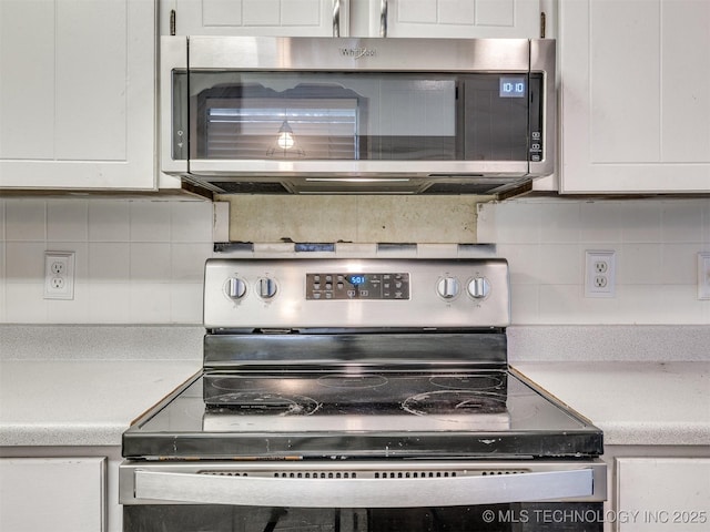 117 W Timberlane St, Broken Arrow, OK 74011 - kitchen featuring stainless steel appliances, decorative backsplash, white cabinets, and light countertops