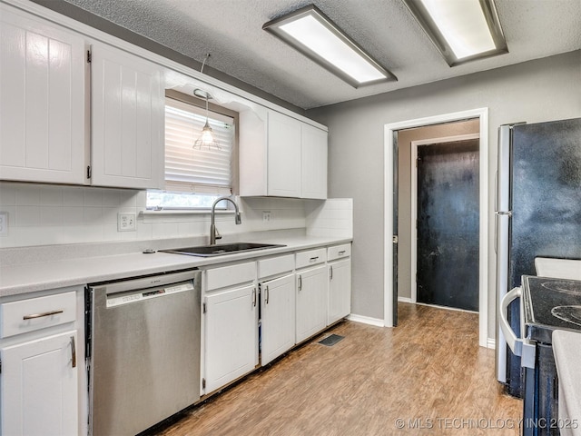117 W Timberlane St, Broken Arrow, OK 74011 - kitchen with stainless steel dishwasher, range, white cabinets, light wood-type flooring, and light countertops
