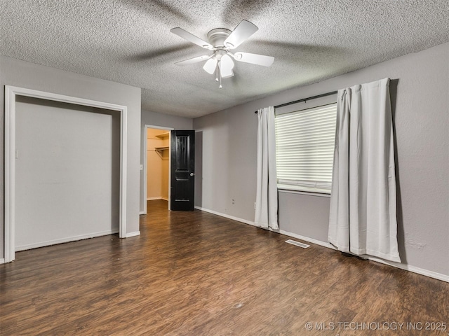 117 W Timberlane St, Broken Arrow, OK 74011 - unfurnished bedroom with wood finished floors, a textured ceiling, ceiling fan, and a spacious closet