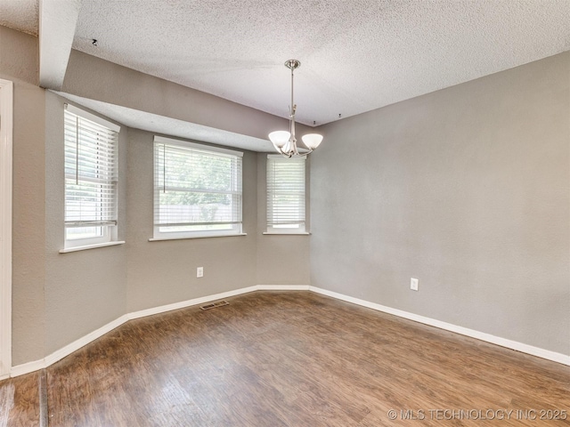 117 W Timberlane St, Broken Arrow, OK 74011 - empty room with wood finished floors, a textured ceiling, and a chandelier