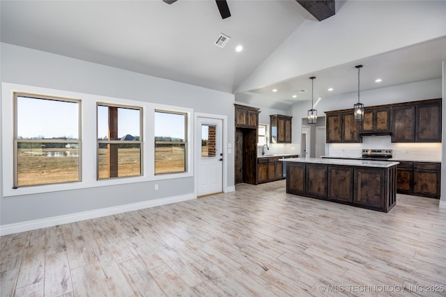 175 Maple Leaf Dr, Durant, OK 74701 - kitchen featuring light countertops, ceiling fan, a center island, stainless steel appliances, and dark brown cabinetry