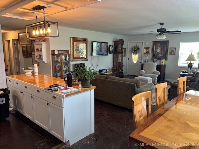 33803 S 4230th Rd, Inola, OK 74036 - kitchen featuring white cabinets, open floor plan, decorative light fixtures, ceiling fan, and a center island