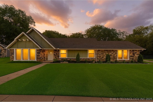 6905 S Redbud Ave, Broken Arrow, OK 74011 - view of front of property featuring a lawn, board and batten siding, and stone siding