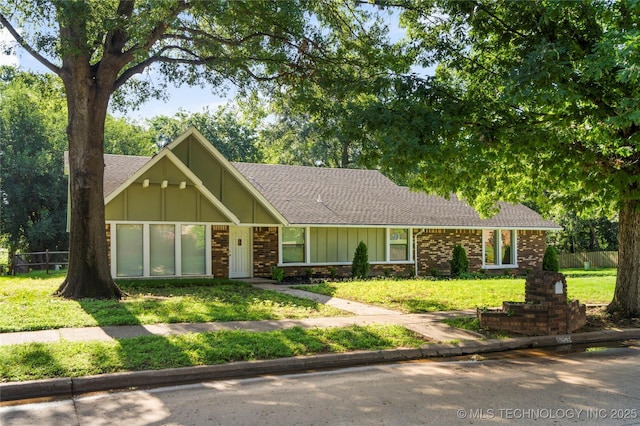 6905 S Redbud Ave, Broken Arrow, OK 74011 - view of front of property featuring board and batten siding, roof with shingles, and brick siding