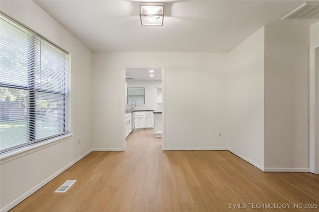 6905 S Redbud Ave, Broken Arrow, OK 74011 - unfurnished living room featuring light wood-style floors and baseboards