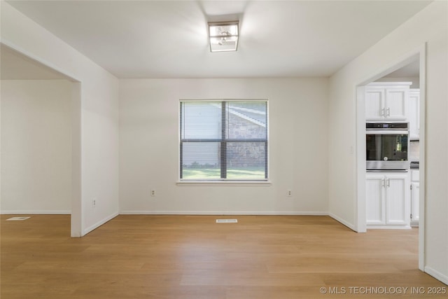 6905 S Redbud Ave, Broken Arrow, OK 74011 - empty room featuring light wood-style floors