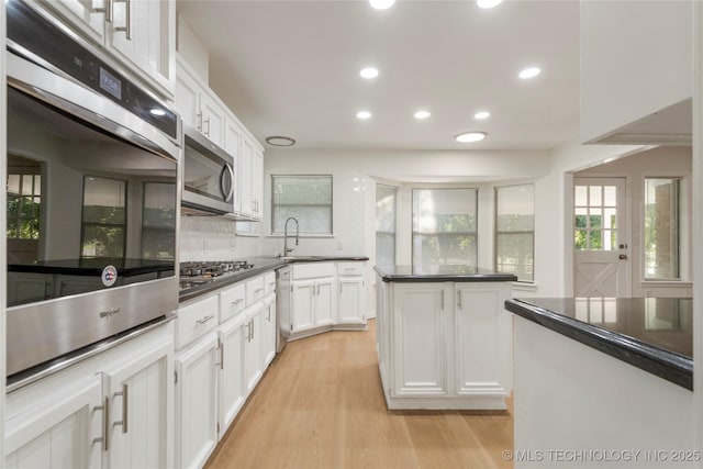 6905 S Redbud Ave, Broken Arrow, OK 74011 - kitchen with stainless steel appliances, dark countertops, white cabinetry, and recessed lighting