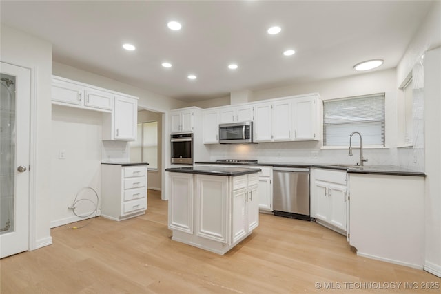 6905 S Redbud Ave, Broken Arrow, OK 74011 - kitchen featuring dark countertops, white cabinets, decorative backsplash, and recessed lighting