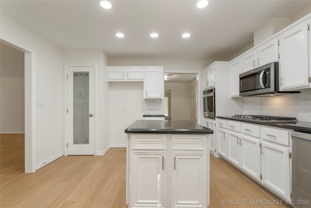 6905 S Redbud Ave, Broken Arrow, OK 74011 - kitchen with dark countertops, white cabinetry, light wood-style floors, appliances with stainless steel finishes, and recessed lighting