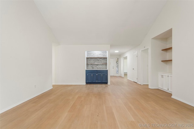6905 S Redbud Ave, Broken Arrow, OK 74011 - unfurnished living room with light wood-style flooring and vaulted ceiling