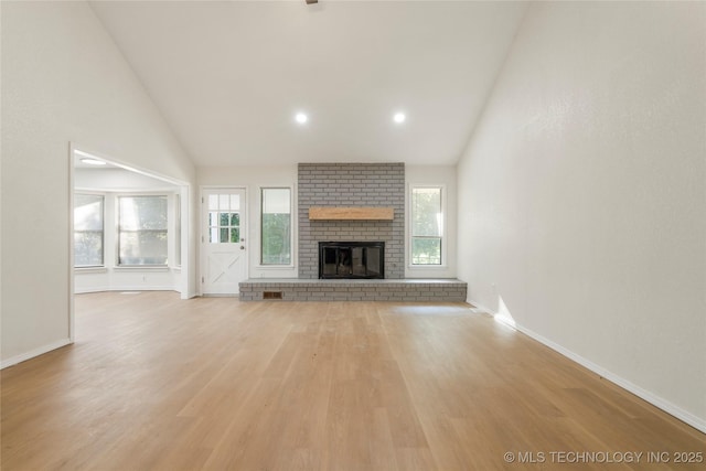 6905 S Redbud Ave, Broken Arrow, OK 74011 - unfurnished living room featuring wood finished floors, high vaulted ceiling, a fireplace, and recessed lighting