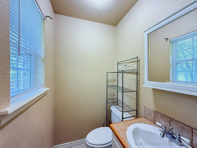 14174 County Road 3501, Ada, OK 74820 - half bathroom with a textured wall, vanity, and a textured ceiling
