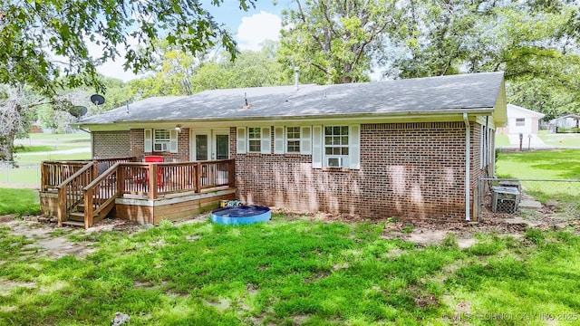 14174 County Road 3501, Ada, OK 74820 - back of house with a wooden deck, brick siding, and roof with shingles