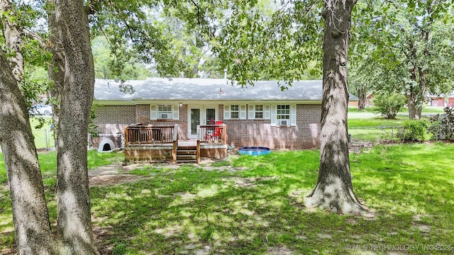 14174 County Road 3501, Ada, OK 74820 - back of house featuring brick siding, a deck, and a yard
