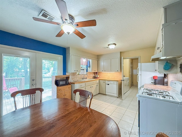 14174 County Road 3501, Ada, OK 74820 - kitchen with white appliances, tasteful backsplash, light countertops, a ceiling fan, and light tile patterned floors