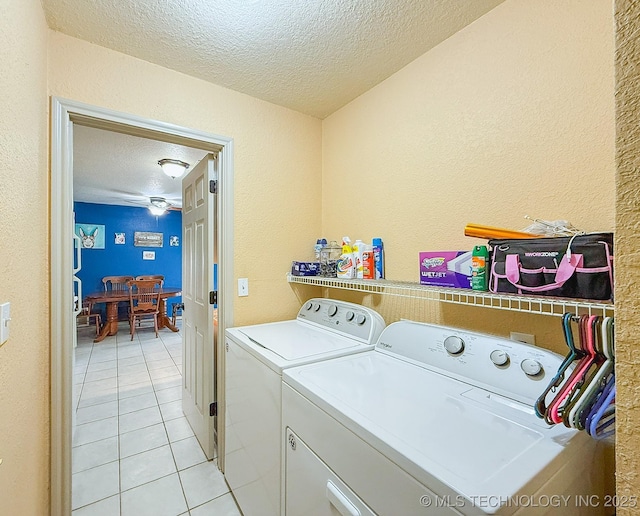 14174 County Road 3501, Ada, OK 74820 - laundry room featuring a textured ceiling, separate washer and dryer, light tile patterned floors, and a textured wall