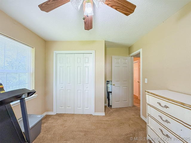 14174 County Road 3501, Ada, OK 74820 - bedroom featuring light colored carpet, a closet, a ceiling fan, and a textured ceiling