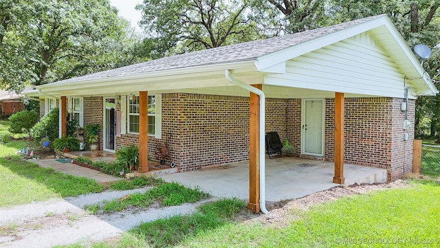 14174 County Road 3501, Ada, OK 74820 - view of property exterior featuring brick siding and a shingled roof