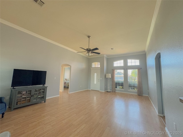 13155 E 132nd St N, Collinsville, OK 74021 - unfurnished living room featuring arched walkways, ceiling fan, ornamental molding, and light wood-style flooring