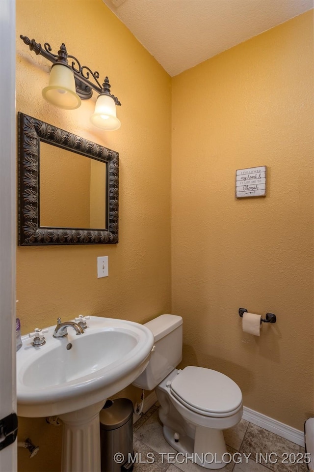 105074 N 3770, Okemah, OK 74859 - bathroom featuring toilet and tile patterned floors
