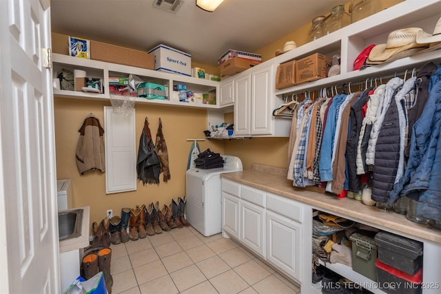 105074 N 3770, Okemah, OK 74859 - laundry area with washer / dryer, cabinet space, and light tile patterned flooring