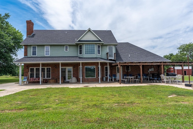 105074 N 3770, Okemah, OK 74859 - rear view of property featuring a chimney, brick siding, and a lawn