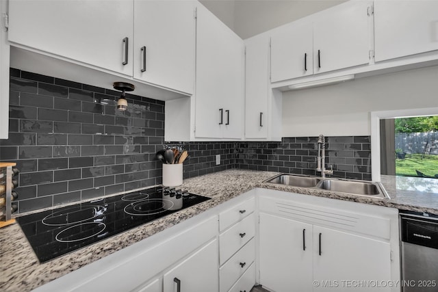4620 S Winston Ave, Tulsa, OK 74135 - kitchen featuring black electric stovetop, stainless steel dishwasher, decorative backsplash, and white cabinetry