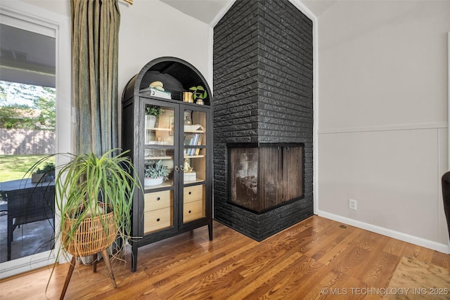 4620 S Winston Ave, Tulsa, OK 74135 - detailed view of wood finished floors and a brick fireplace