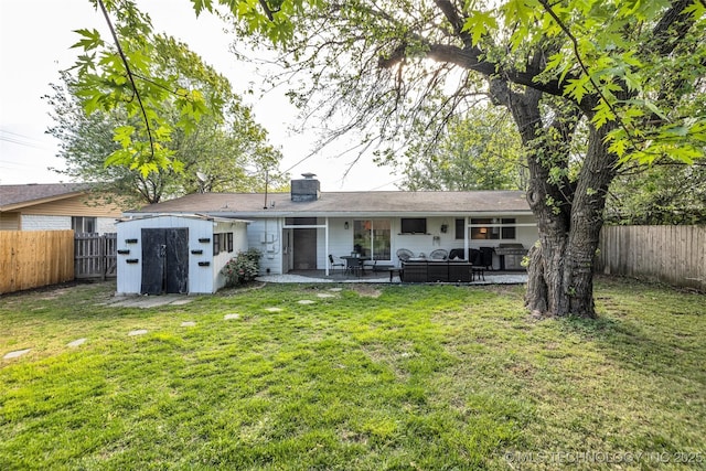 4620 S Winston Ave, Tulsa, OK 74135 - back of house with a fenced backyard, a patio area, a chimney, and a storage unit