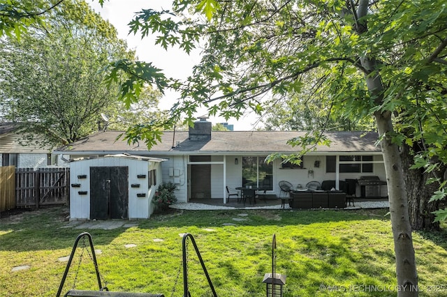 4620 S Winston Ave, Tulsa, OK 74135 - back of house featuring a storage shed, an outdoor living space, a patio area, and a chimney